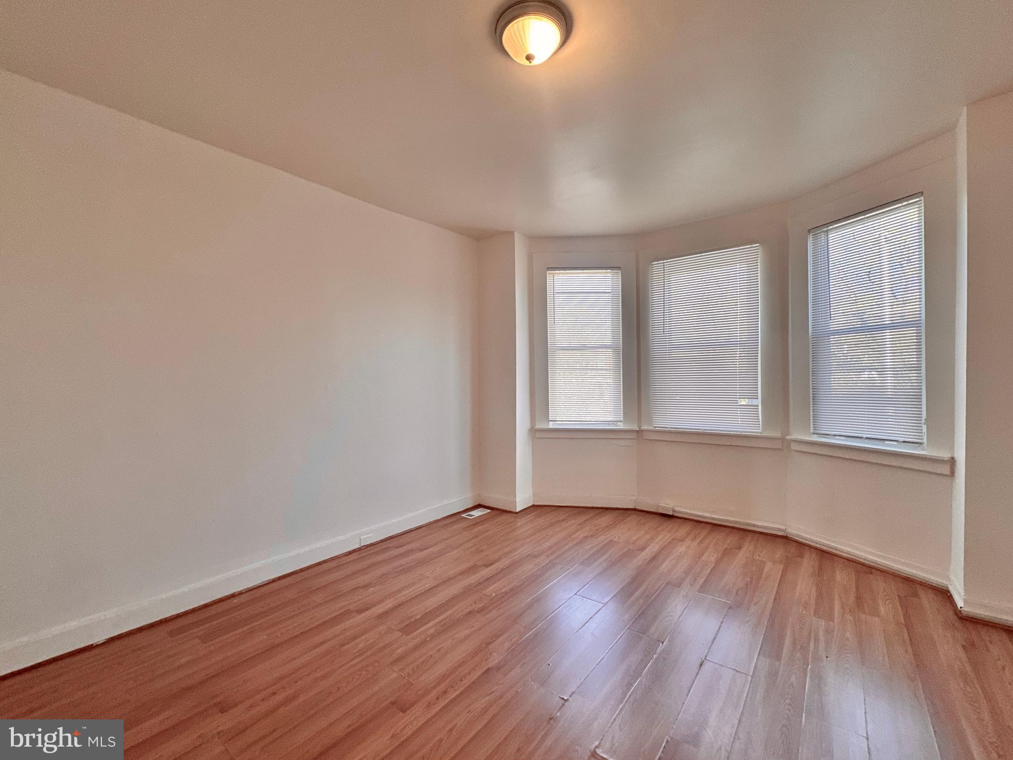 2770 The Alameda Baltimore, MD 21218 - Photo 20 of 33 an empty room with wooden floor and windows