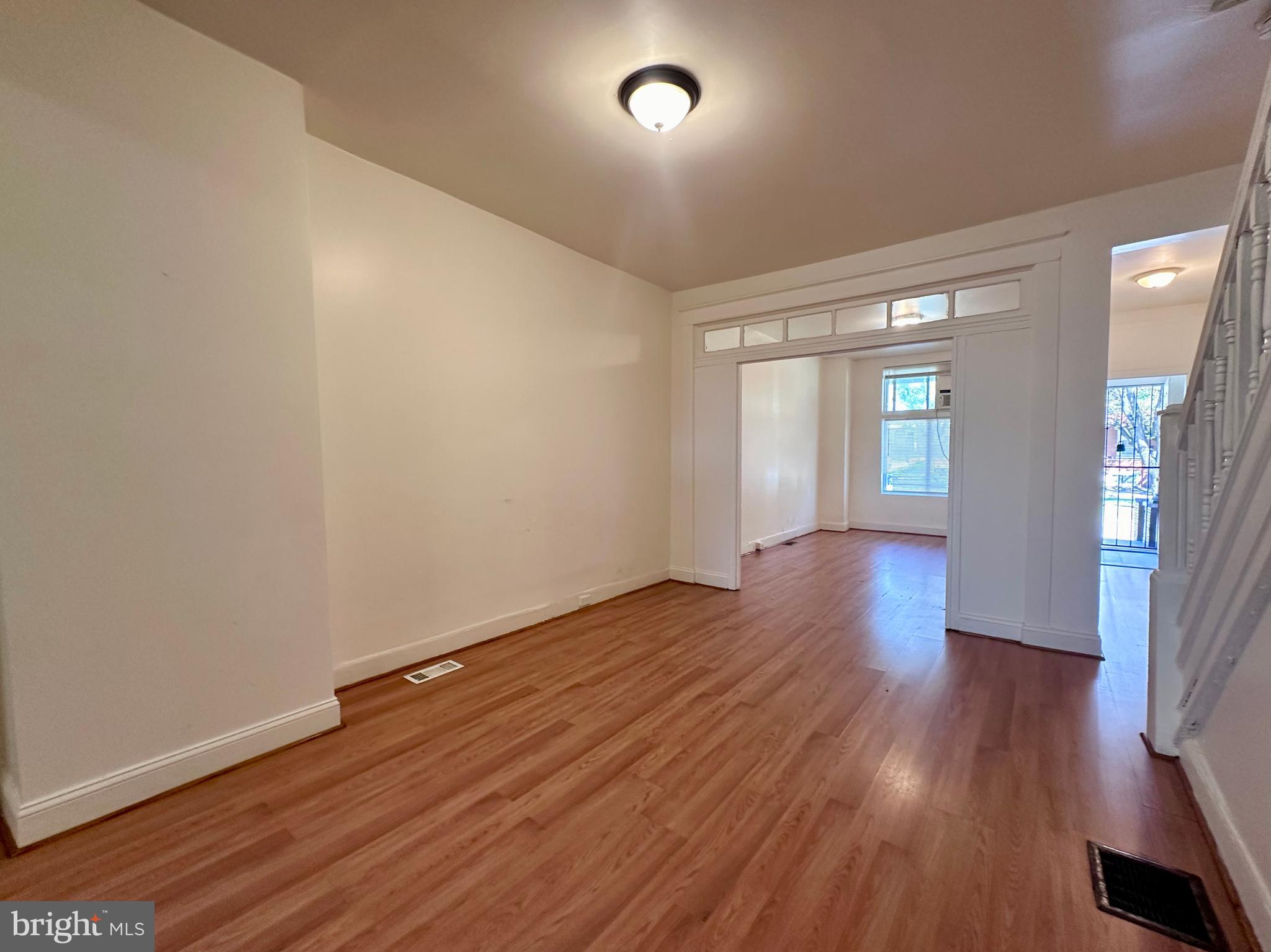 2770 The Alameda Baltimore, MD 21218 - Photo 26 of 33 wooden floor in an empty room with a window