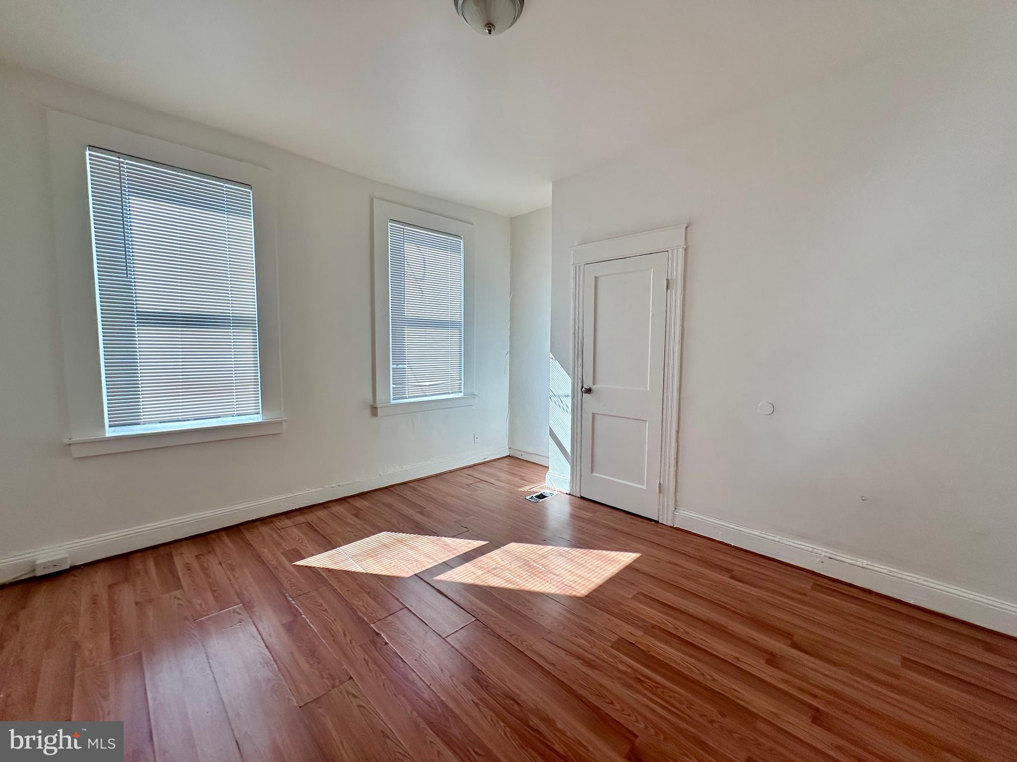 2770 The Alameda Baltimore, MD 21218 - Photo 9 of 33 an empty room with wooden floor and windows