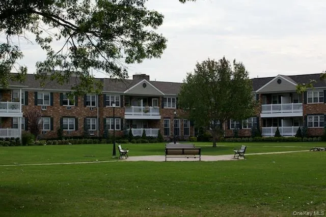 a front view of building with yard and green space