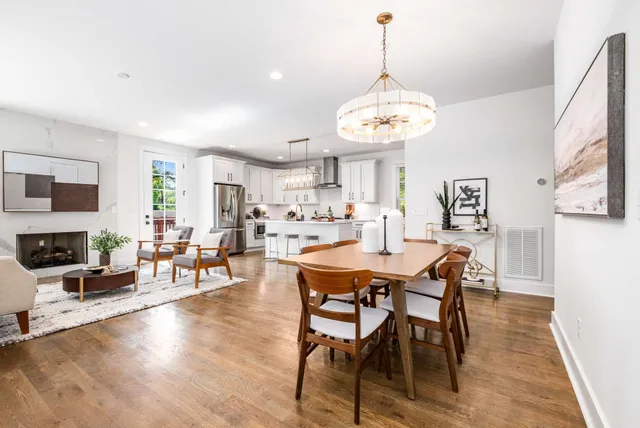a view of a dining room with furniture wooden floor and chandelier