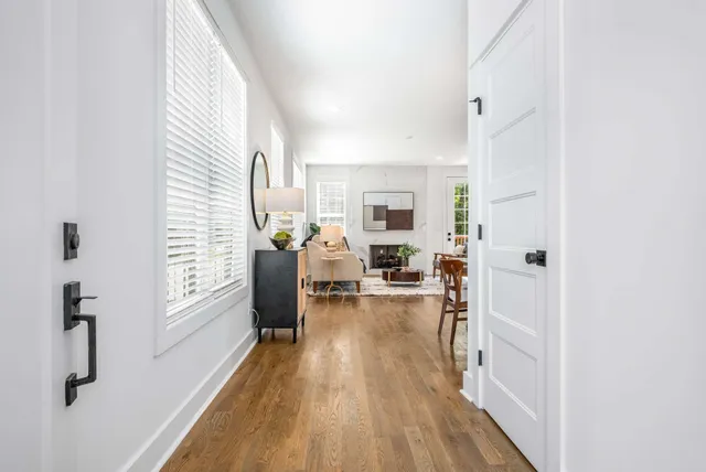a view of a living room with furniture and wooden floor