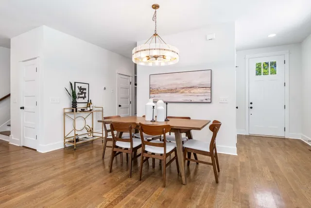 a view of a dining room with furniture and wooden floor