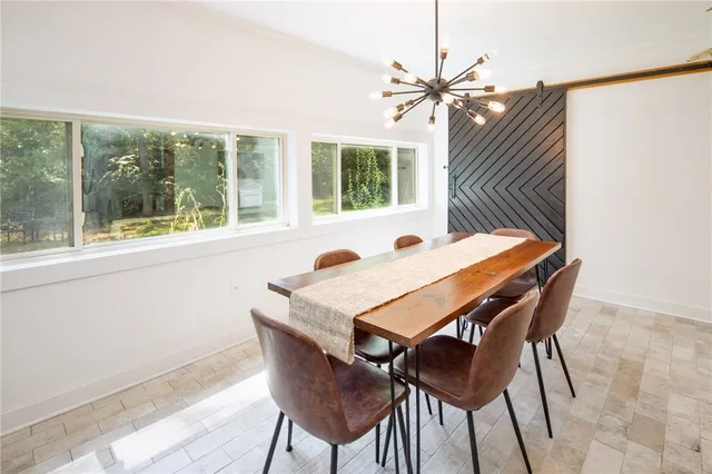 a view of a dining room with furniture and window