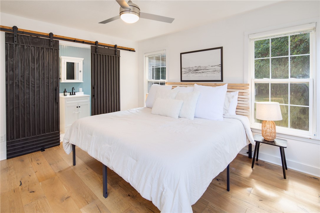 833 Enfield Street Bryan, TX 77802 - Photo 17 of 33 a spacious bedroom with a bed and a table in it