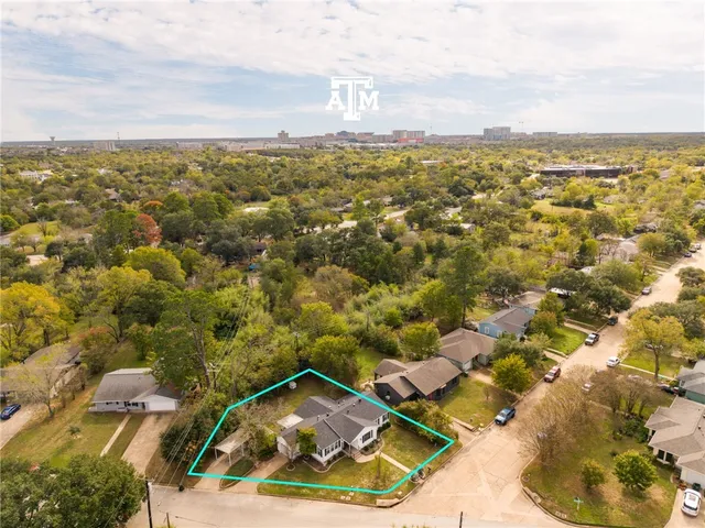 an aerial view of residential houses with outdoor space