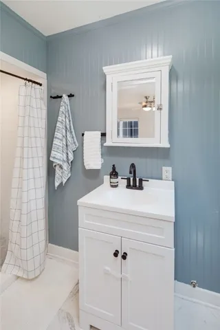 a bathroom with a sink vanity and mirror