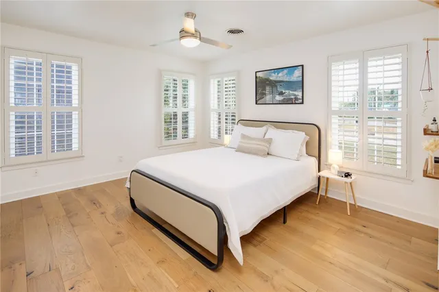 a bedroom with a large bed and a window