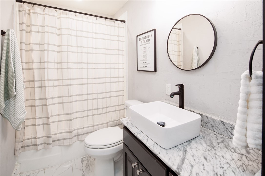 833 Enfield Street Bryan, TX 77802 - Photo 23 of 33 a bathroom with a sink a toilet and a mirror
