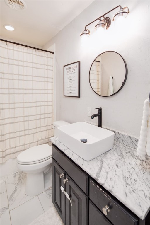 833 Enfield Street Bryan, TX 77802 - Photo 24 of 33 a bathroom with a sink a toilet and a mirror