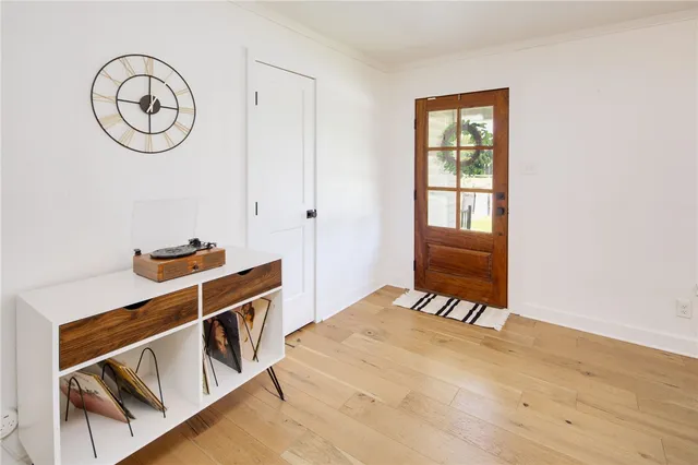 a view of a room with wooden floor and white walls