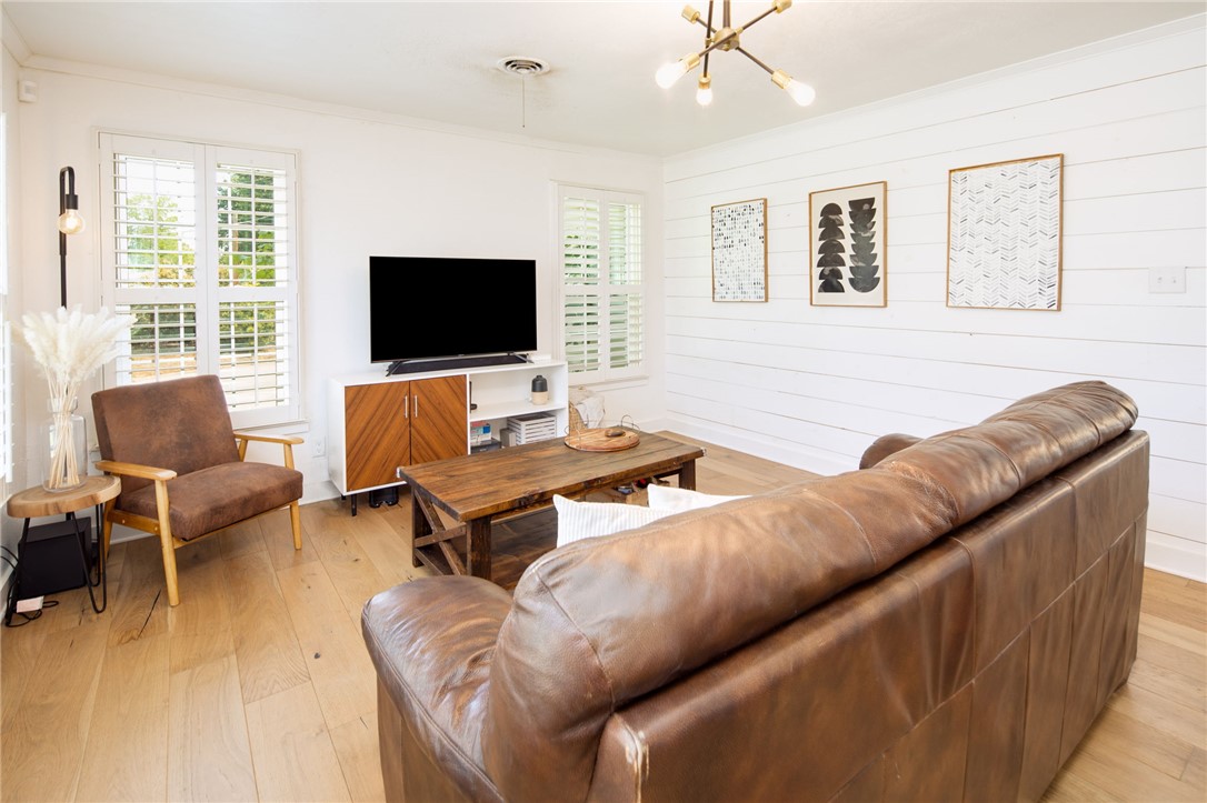 833 Enfield Street Bryan, TX 77802 - Photo 7 of 33 a living room with furniture and a flat screen tv