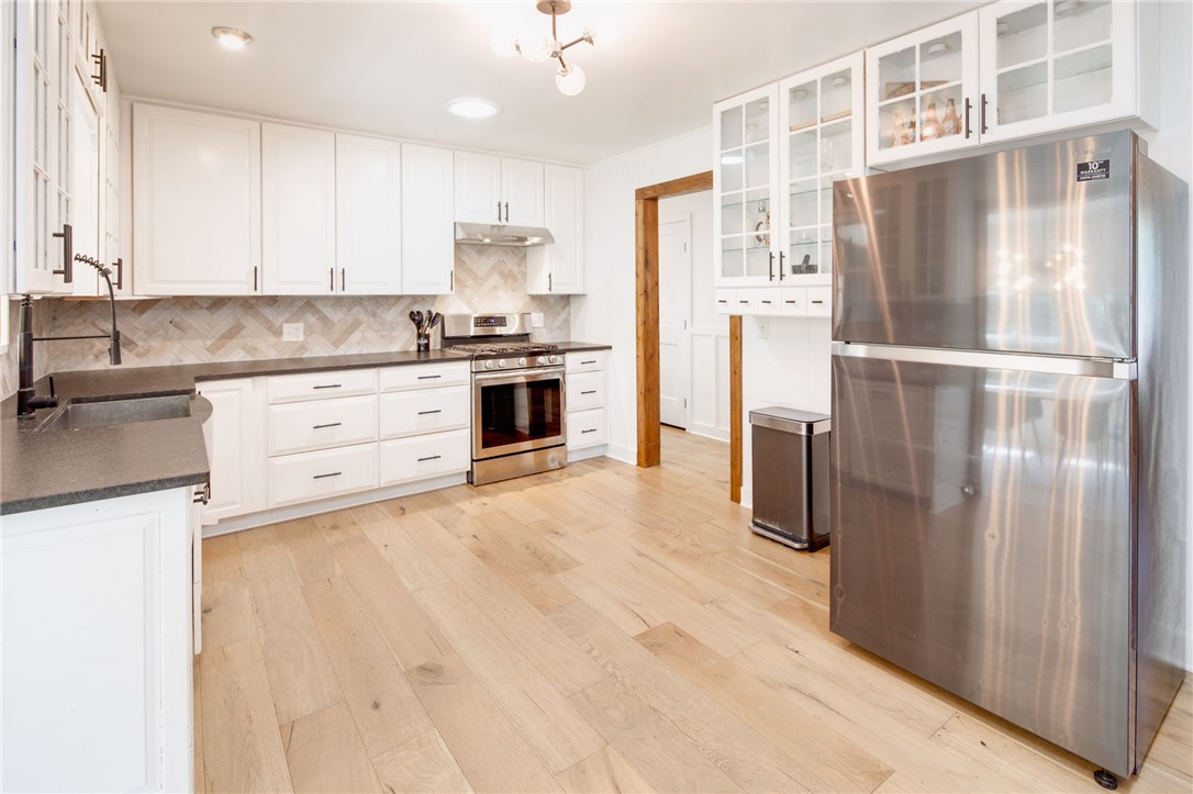 833 Enfield Street Bryan, TX 77802 - Photo 9 of 33 a kitchen with stainless steel appliances a refrigerator sink and cabinets
