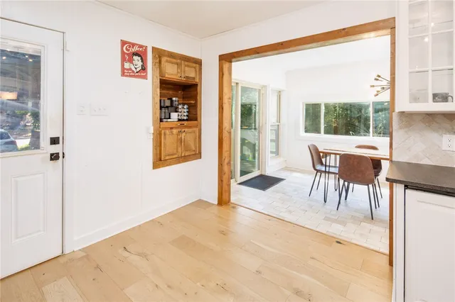 a dining room with furniture and a window