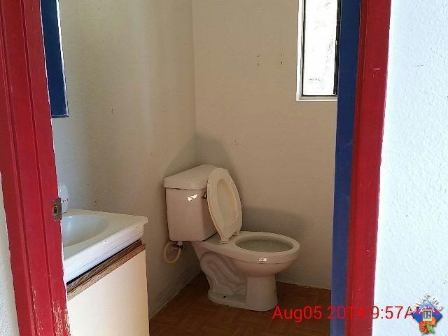 82201 6th Street Trona, CA 93562 - Photo 5 of 6 a white toilet sitting next to a bathroom sink