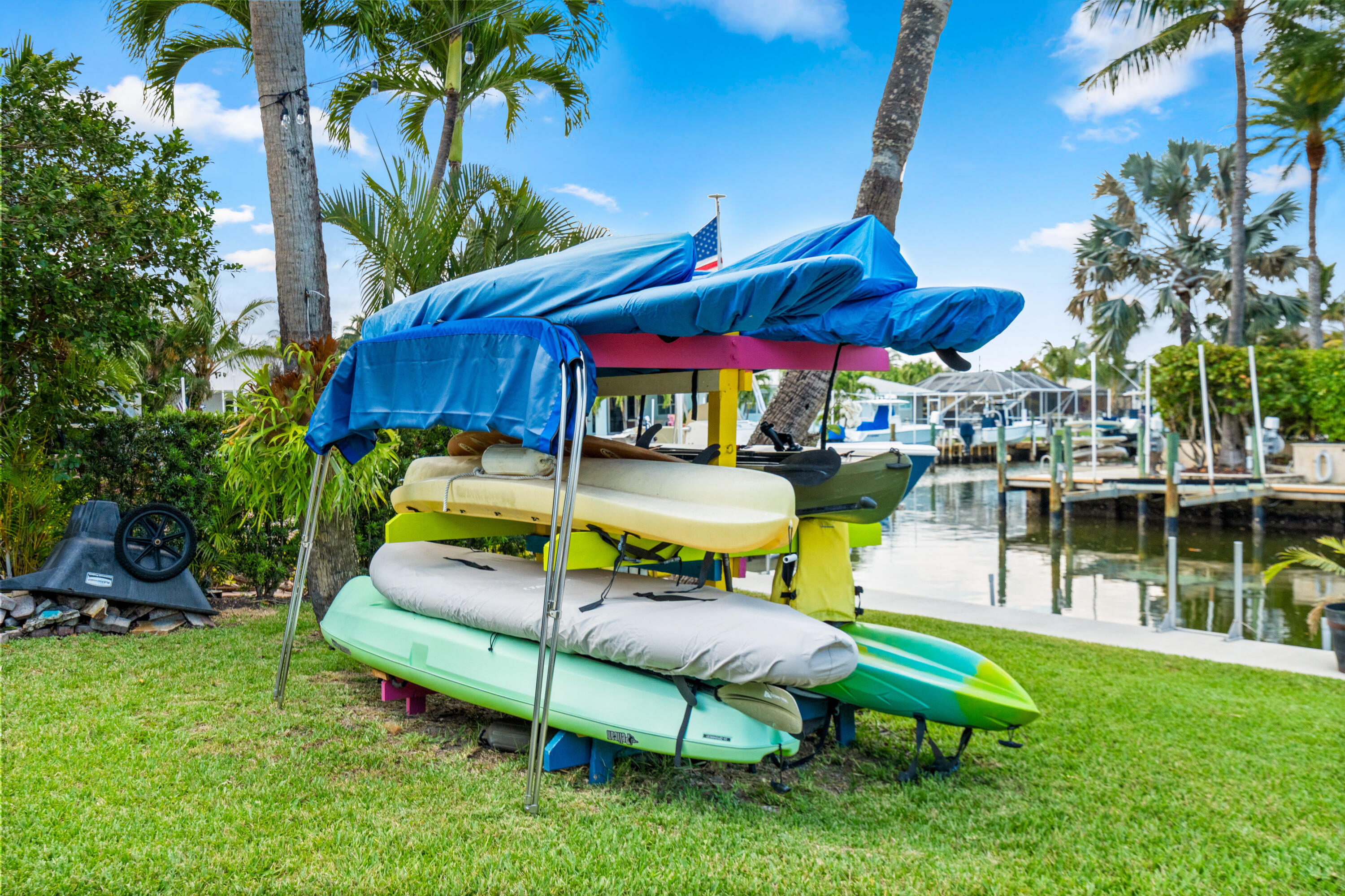 249 Center Street, Unit 2C Jupiter, FL 33458 - Photo 26 of 29 a view of a swimming pool with a table and chairs under an umbrella