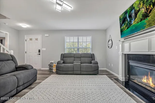a living room with furniture and a ceiling fan