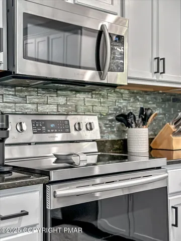 a spacious bedroom with a bed and wooden floor