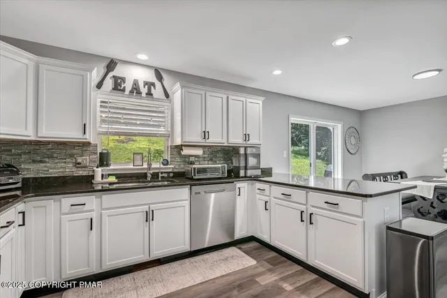 a living room with a bed and a night stand