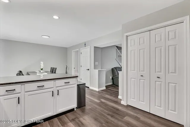 a view of a workspace with furniture and a window