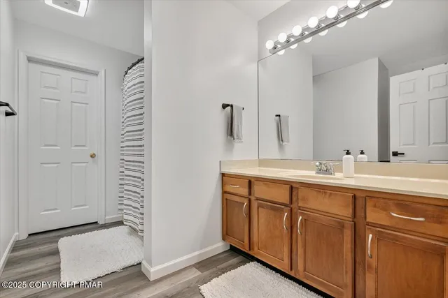 a living room with furniture a clock and wall