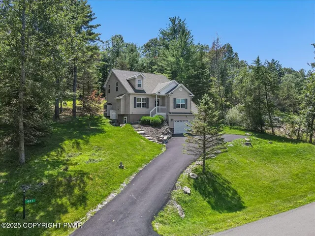 a front view of a house with a yard table and chairs
