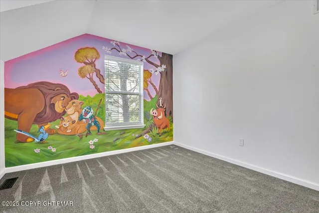 an aerial view of residential houses with outdoor space and trees
