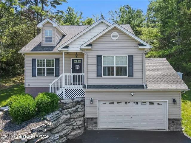 a front view of a house with a garden