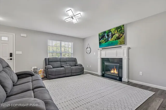 a living room with a fireplace a large window and a fireplace