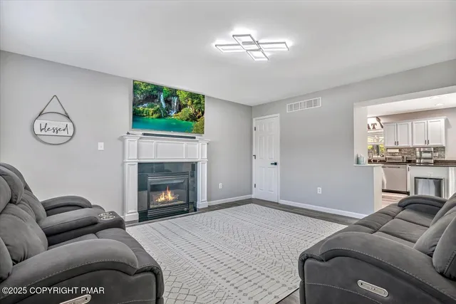 a living room with furniture ceiling fan and a window