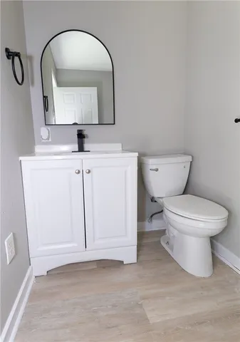 a white toilet sitting next to a bathroom sink
