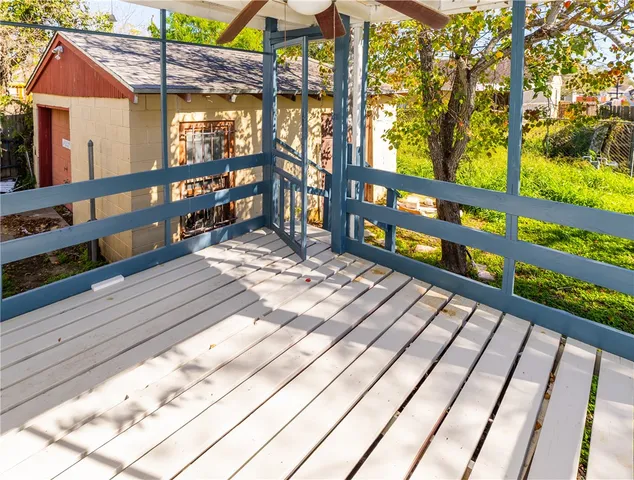 a view of a balcony with wooden floor