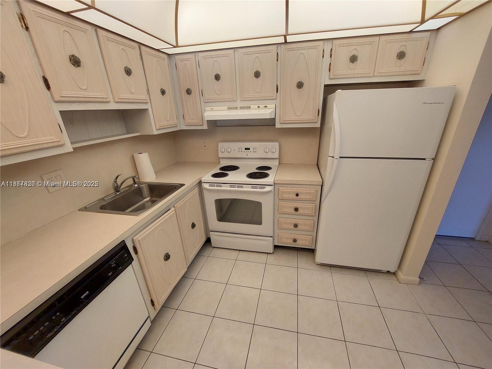 a kitchen with cabinets a refrigerator and a stove