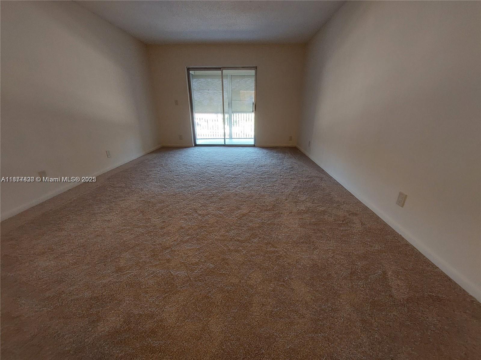 257 South Cypress Road, Unit 438 Pompano Beach, FL 33060 - Photo 6 of 20 an empty room with windows