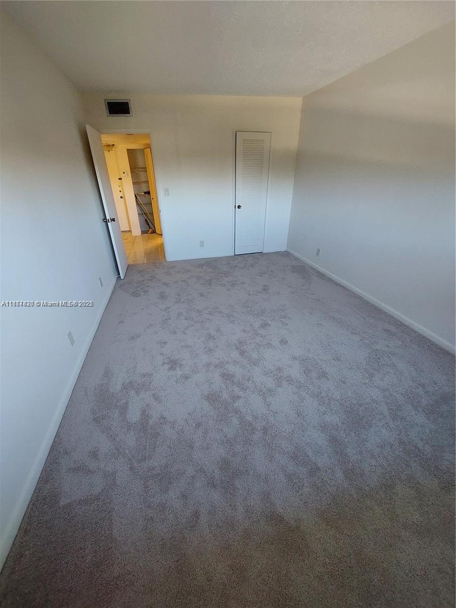 257 South Cypress Road, Unit 438 Pompano Beach, FL 33060 - Photo 9 of 20 an empty room with a mirror