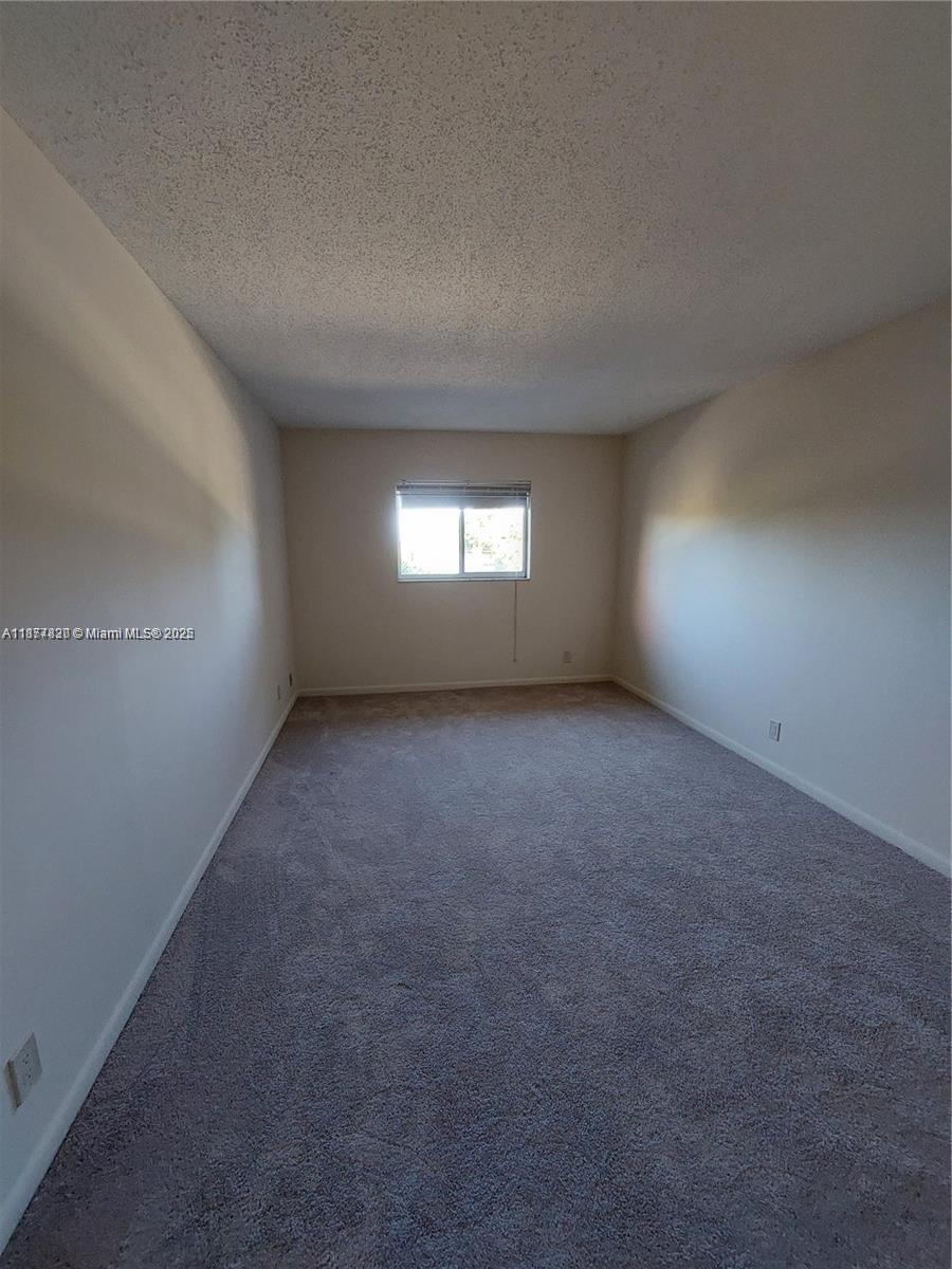 257 South Cypress Road, Unit 438 Pompano Beach, FL 33060 - Photo 10 of 20 wooden floor and window in an empty room