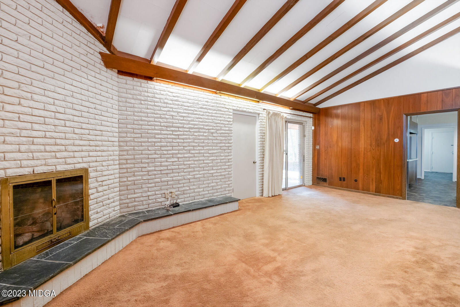 1460 Lone Oak Road Macon, GA 31211 - Photo 14 of 34 a view of an empty room with wooden floor and a fireplace