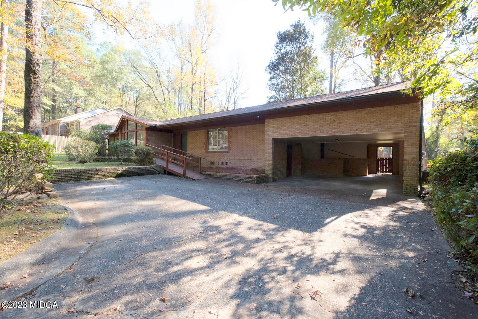 1460 Lone Oak Road Macon, GA 31211 - Photo 27 of 34 a front view of a house with a yard and garage