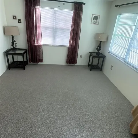 a view of room with window and furniture