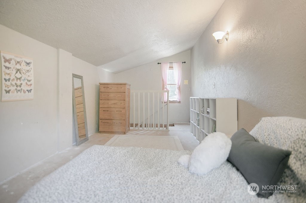 2038 Abernathy Creek Road Longview, WA 98632 - Photo 22 of 37 a bedroom with a bed and a couch