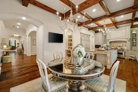a kitchen with dining table and a chandelier