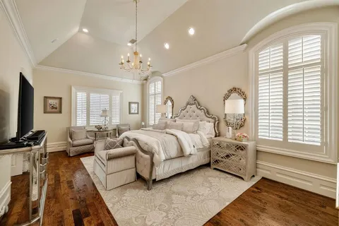 a bedroom with bed and a large window
