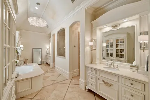 a spacious bathroom with a granite countertop sink a mirror and a shower