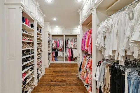 a view of walk in closet with clothes