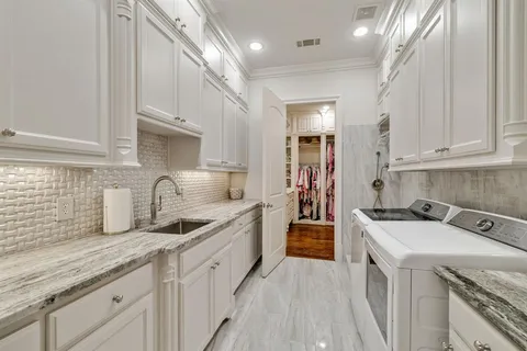 a kitchen that has a sink and a stove
