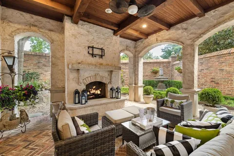 a living room with furniture fireplace and potted plants