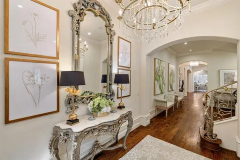 a living room with furniture a chandelier and a rug