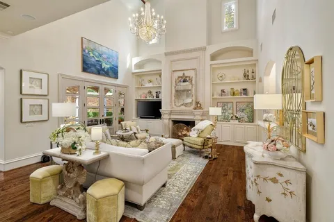 a living room with fireplace furniture and a chandelier