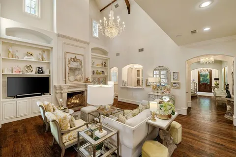 a living room with furniture a flat screen tv and kitchen view