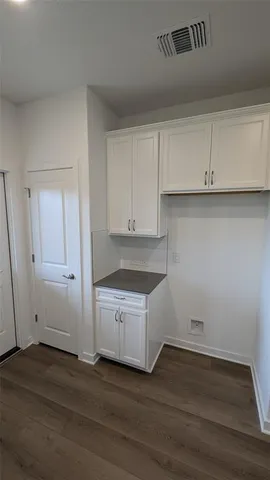 a view of a kitchen with wooden floor